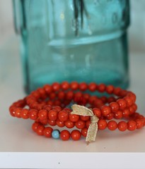 Red prayer bids with a recycled blue glass bottle , shallow depth of field 