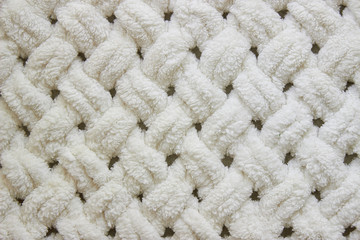 knitted large blanket handmade, super chunky yarn, trendy concept. Close up of knitted blanket, background
