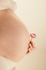 happy expectant mother with flower