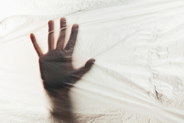 Human hand on background of plastic trash polluting planet. Stop the use of plastic packaging and...
