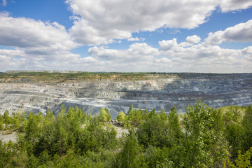 Fototapeta na wymiar Big quarry abest ore mining at summer day