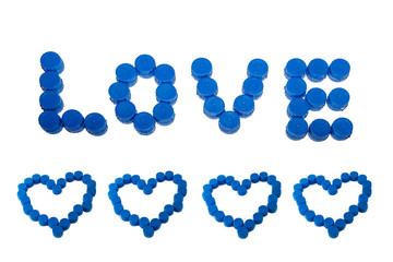 Heart border of blue plastic plugs with the word love on top isolated on white background