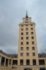 Fototapeta na wymiar tower building with symmetric windows on a cloudy day