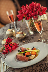roasted duck breast with cabbage and pancake served on white plate with glass of wine, winter and seasonal food, product photography for restaurant