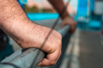 detail of a man's hands a man working carrying canvases and fences