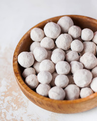 Cranberries in powdered sugar in a plate close-up.