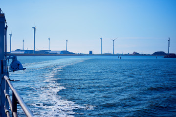 Wind turbine  in the background blue sky and sea