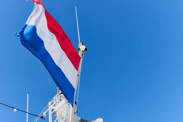 dutch flag on the mast of the ship