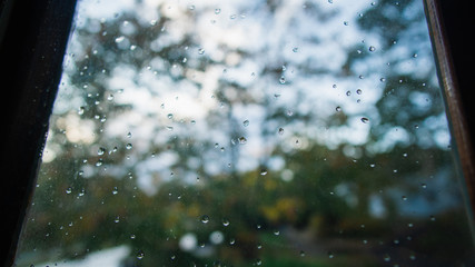 Rain drops on a window. Bright colors in the background