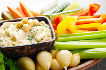 Low angle view at vegetable Hummus dip dish topped with chickpeas and olive oil