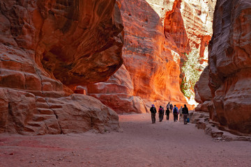 Tourists in the gorge leading to the visit of the archaeological site of Petra in Jordan.