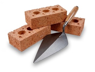 A set of house building bricks and trowel, isolated on a white background - obrazy, fototapety, plakaty