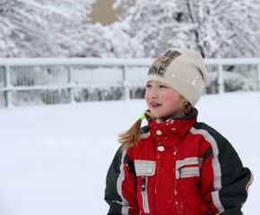 Girl in a ski suit in winter. Winter and children.