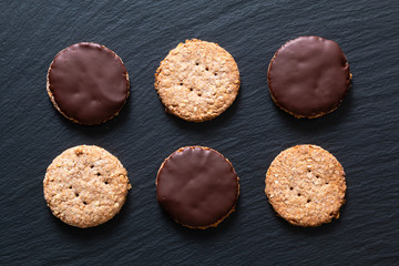 Healthy food concept fresh baked Homemade organic digestive Oat and wheat Bran chocolate dipped Cookies with copy space