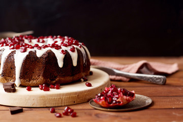 chocolate cake with pomegranate on a wooden table, a cozy breakfast, English tea party, chocolate...