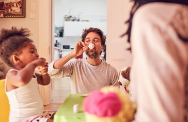 Father and daughter enjoying imaginary tea party