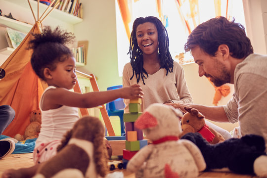 Young family playing with wood blocks