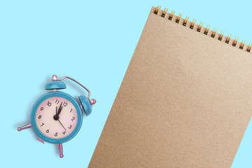 Clipboard with empty white paper with read alarm clock on solid