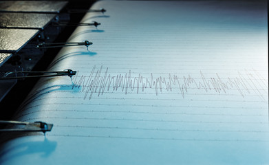 Swinging needle of seismograph at earthquake.