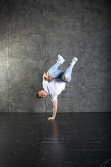 Fototapeta na wymiar Breakdance action, dancer posing in dance studio