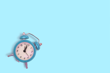 retro alarm clock on blue background. Concept of time with free space for text