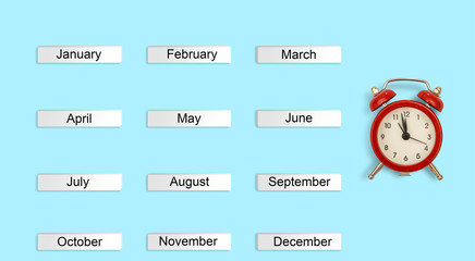 calendar autumn months and red alarm clock on blue background. Concept time Creative Top view Flat Lay Minimal style Copy space