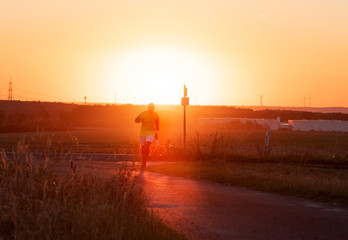 Fototapeta premium A man running in the golden mist of sunset.