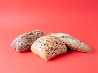 bread loaves isolated on red background