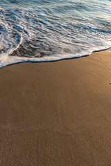 Fototapeta na wymiar Wet beach sand and ocean