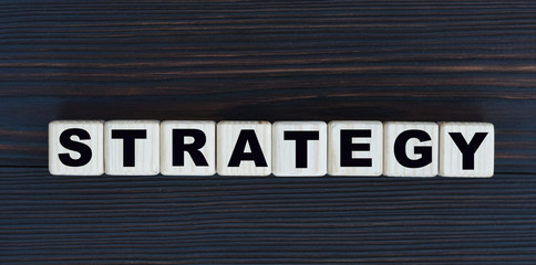 concept word strategy on cubes on a wooden background