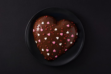 Heart shaped cake for Valentine's Day or mother's day on black background. Top view. 