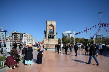  Tourists on Istanbul's Taksim square at the main national monument - the Republic monument"