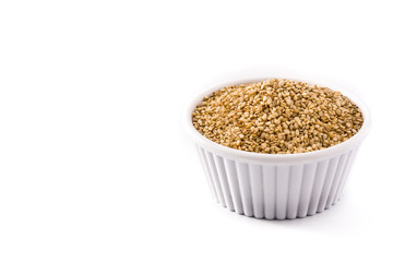 Golden flax seeds in white bow isolated on white background. Copy space