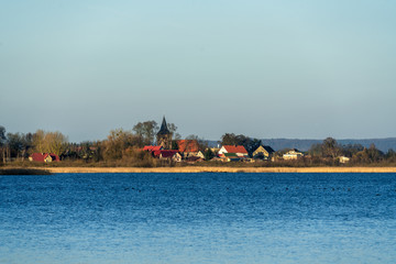 Fototapeta premium The village Weltyn in Poland seen across the lake