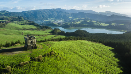 Drone aerial view of "Castelo Branco" historic monument with "Furnas" lagoon on background in Sao Miguel island, Azores, Portugal.