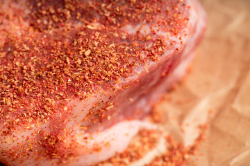 Raw fresh meat with spices on the rustic background. Selective focus. Shallow depth of field.