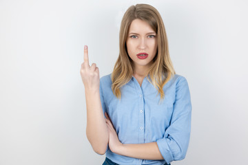 portrait of young blond brutal woman showing fuck off sign on isolated white background, body language