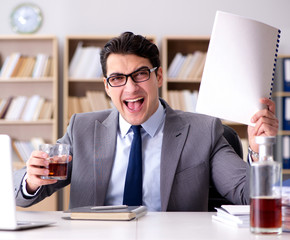 Young businessman drinking from stress