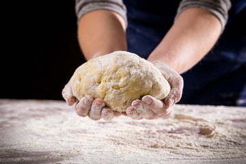 woman's hands holding the dough