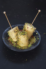 Saffron, Almond and Pistachio Ice Cream Kulfi, Indian Style, ready to eat.  Top view, selective focus