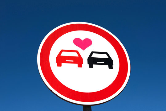 Heart sticker on a no overtaking road sign, Portugal