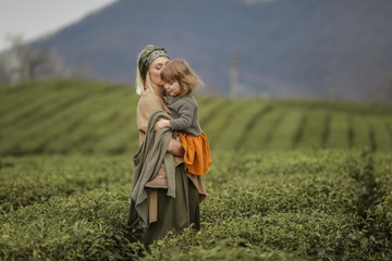 Mom Cuddles Baby Outdoors, family of two people mother and daughter come into contact with nature