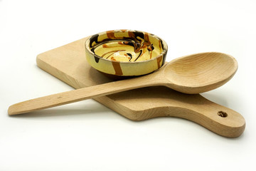 Wooden kitchen utensils on white background. Cutting board and shovels.
