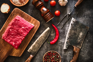 Fresh raw piece of beef with a meat cleaver for a butcher.