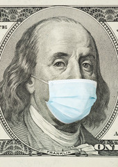 100 dollar banknote with medical mask. The concept of coronavrius epidemic