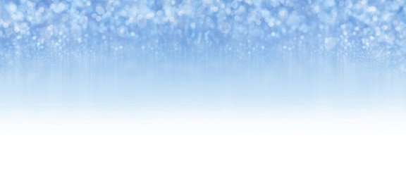 Abstract sparkle glitter lights background. Selective focus.  Pastel blue color. Smooth gradient to white. Shine bokeh effect. For party, holidays, celebration. Banner for website. 