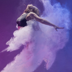 Girl in pointe shoe in dust cloud profile shot