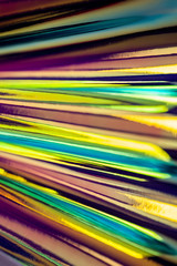 Holographic abstract colorful backdrop. Holographic color wrinkled foil. Iridescent art. Blurred background.