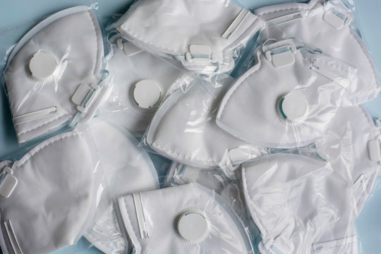A lot of medical face dust masks, disposable FFP3 respirators. Concept of coronavirus, air pollution, virus, flu, infectious diseases and precautions. A stock face mouth masks