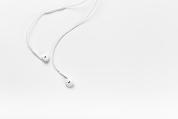 White modern headphones with a headset on a light gray background